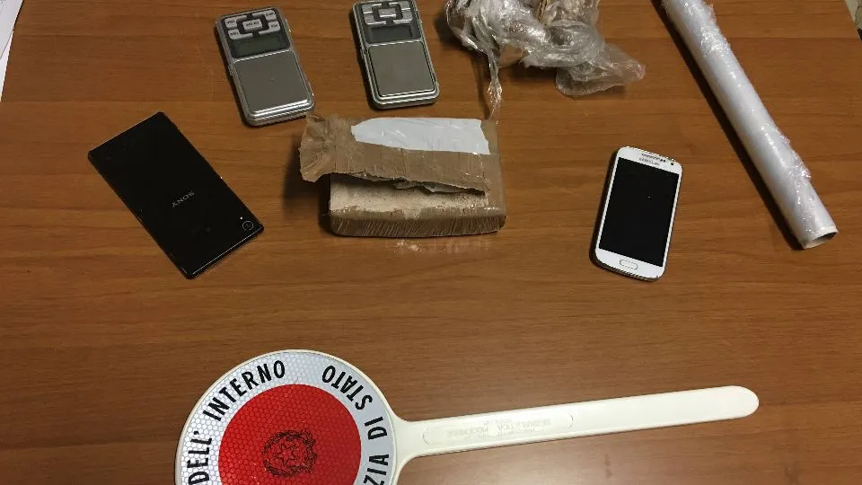 Il panetto di droga e il materiale per confezionarlo in dosi